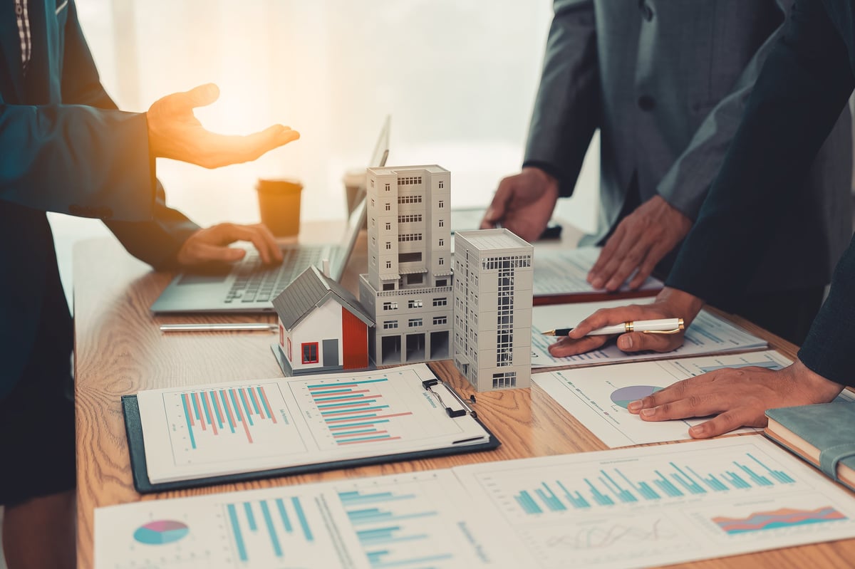 Real estate professionals discussing property investment